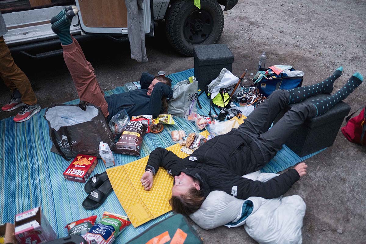 Resupplying (lying on picnic blanket with foot and feet up)